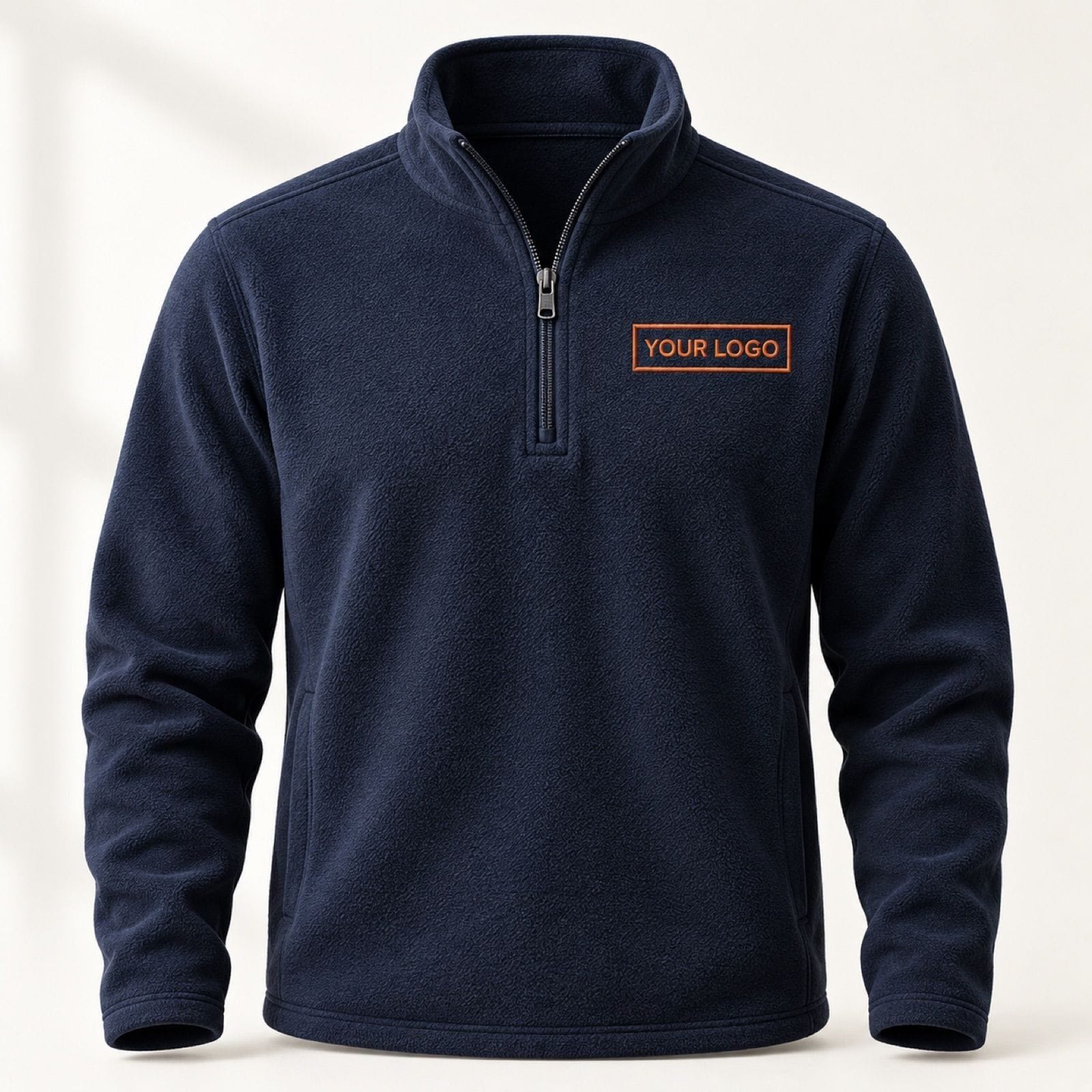 Navy quarter-zip fleece with a rust-thread "YOUR LOGO" placeholder embroidered on the left chest, a rendered example